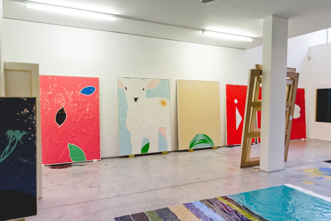 Gary Hume's colorful high-gloss paintings displayed in a studio space, ready for exhibition.