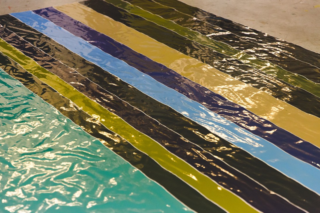 Gary Hume's colorful high-gloss enamel paintings on warped paper with undulating surfaces in turquoise, yellow, blue, and black.