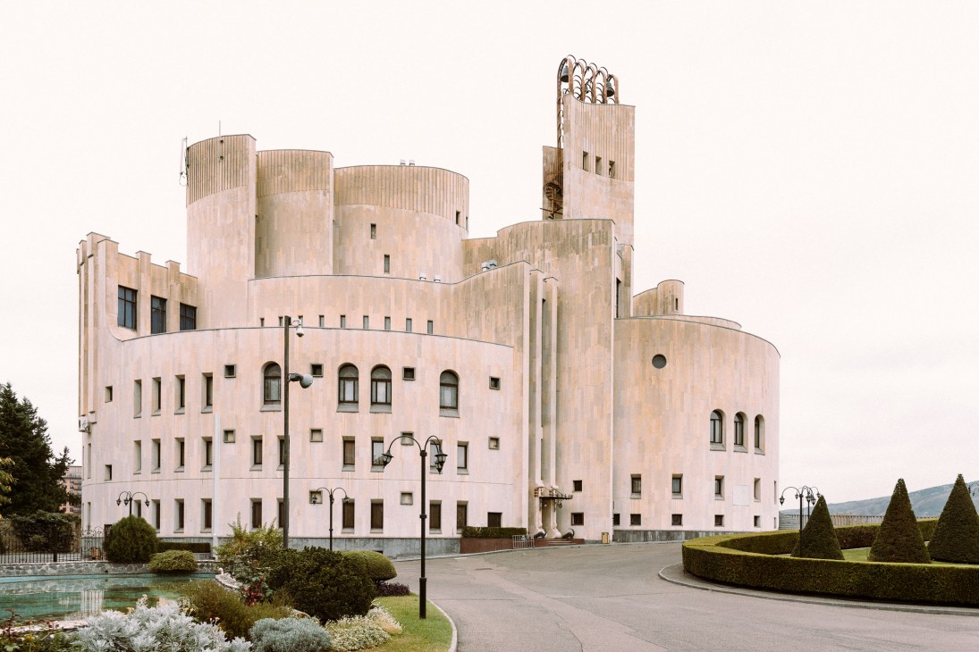 The Kakhidze Music Center's postmodern façade with cylindrical towers and ornamental details.
