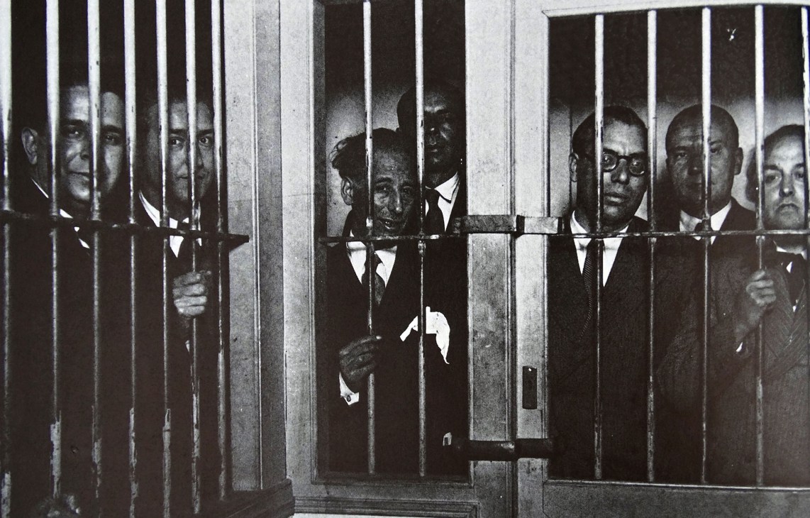 Black and white historical photograph of men in suits behind prison bars, including Catalan leader Lluis Companys in the centre.