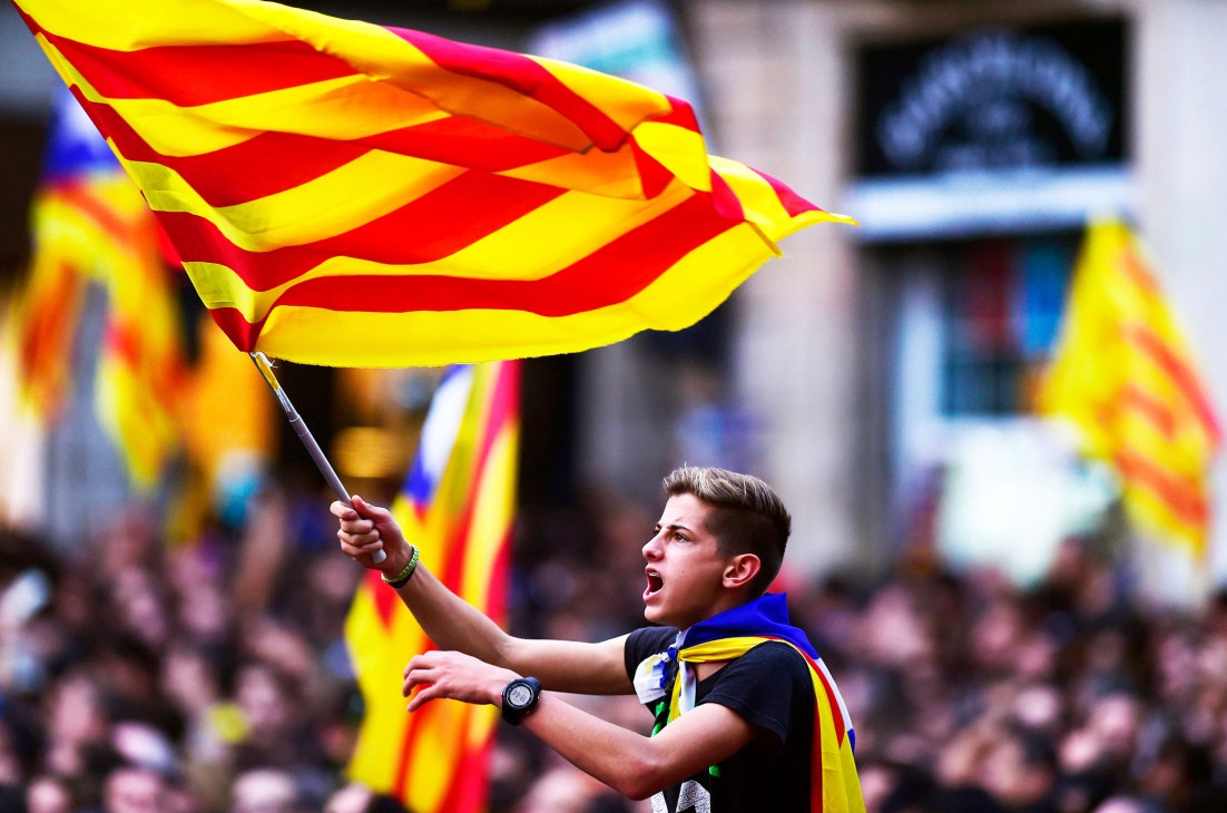 A boy waves a Catalan flag at a pro-independence rally in Barcelona.