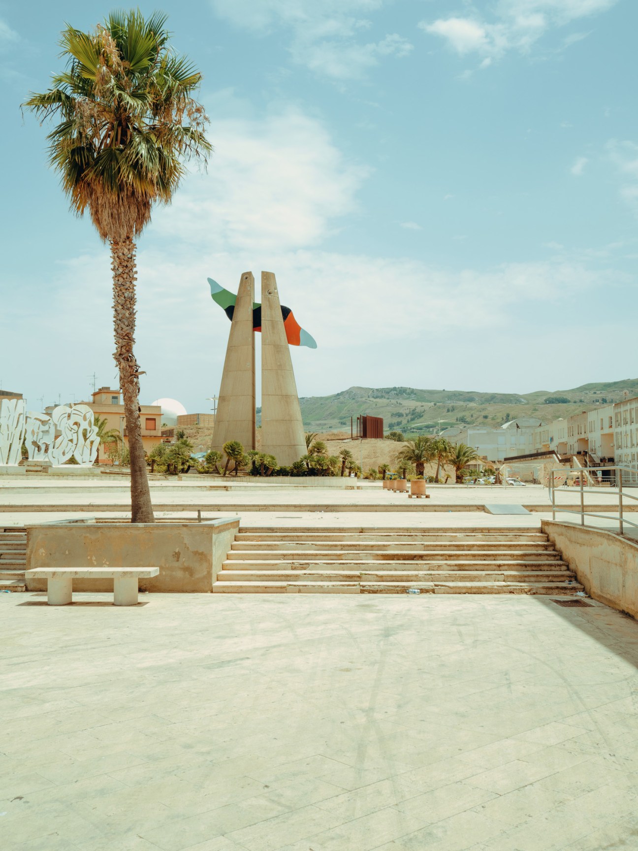 Tall colorful civic tower with postmodern design elements in Gibellina Nuova by Alessandro Mendini