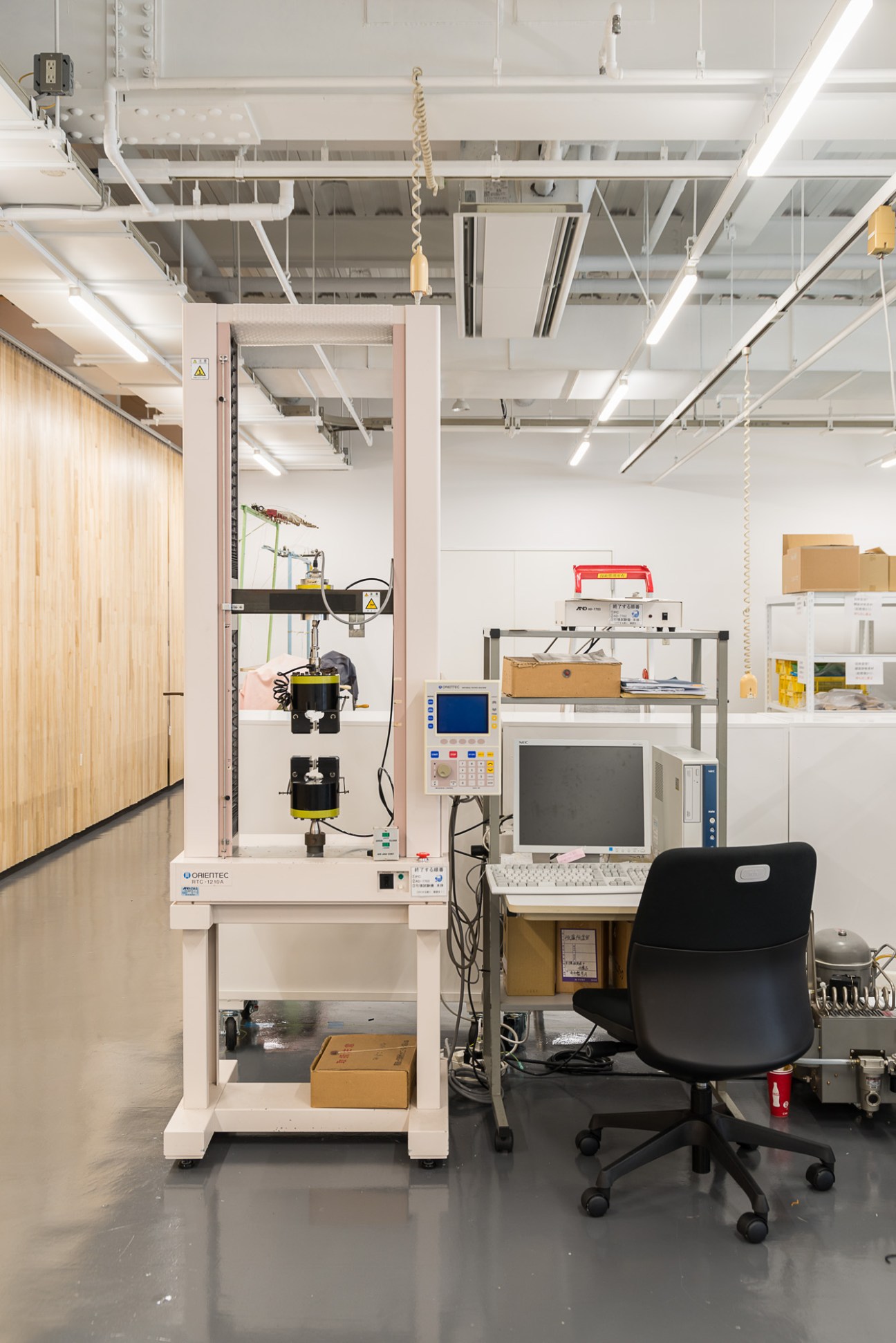 Testing equipment in Goldwin's laboratory with fabric testing machine and computer workstation.