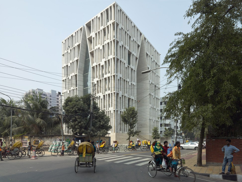 Gulshan Society mosque designed by Kashef Chowdhury, a white modernist building with vertical ribbed facade on a busy Dhaka street.