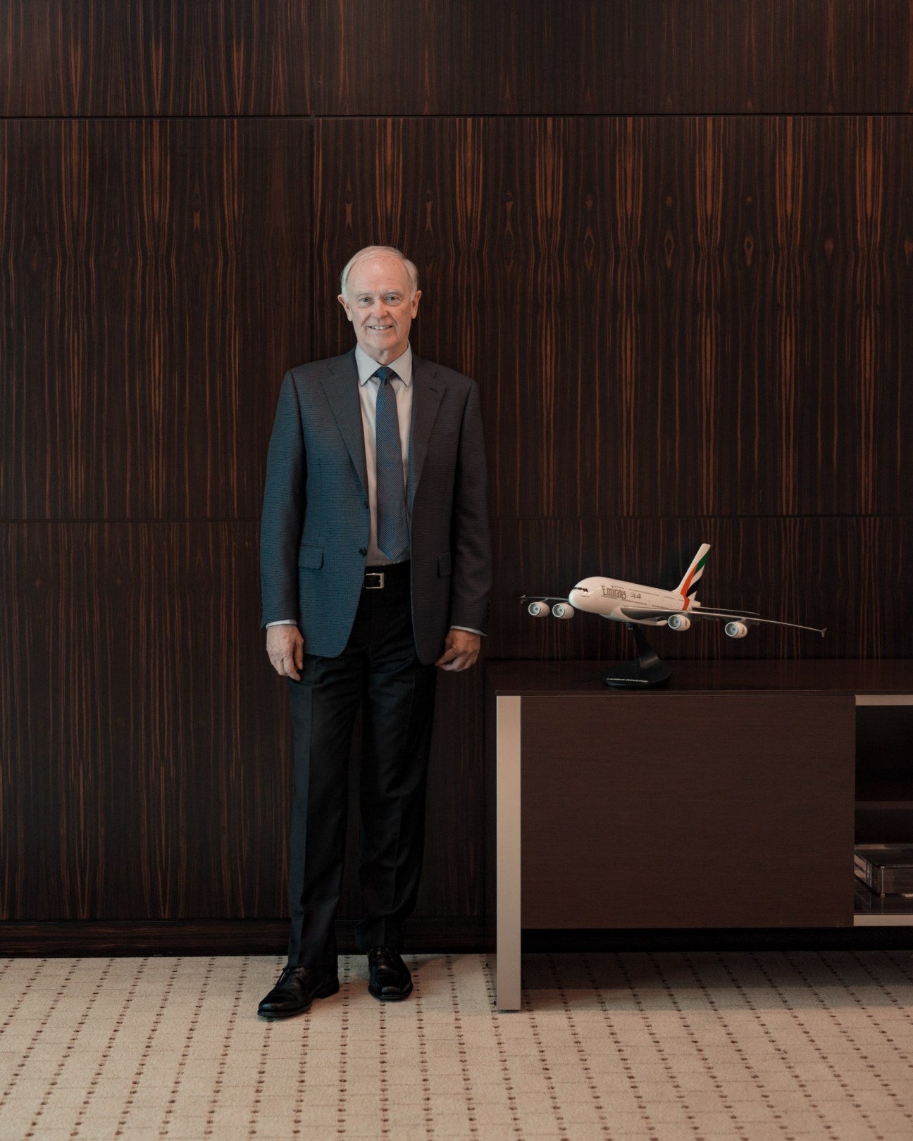 Emirates president Sir Tim Clark stands beside a model Emirates aircraft in his office.