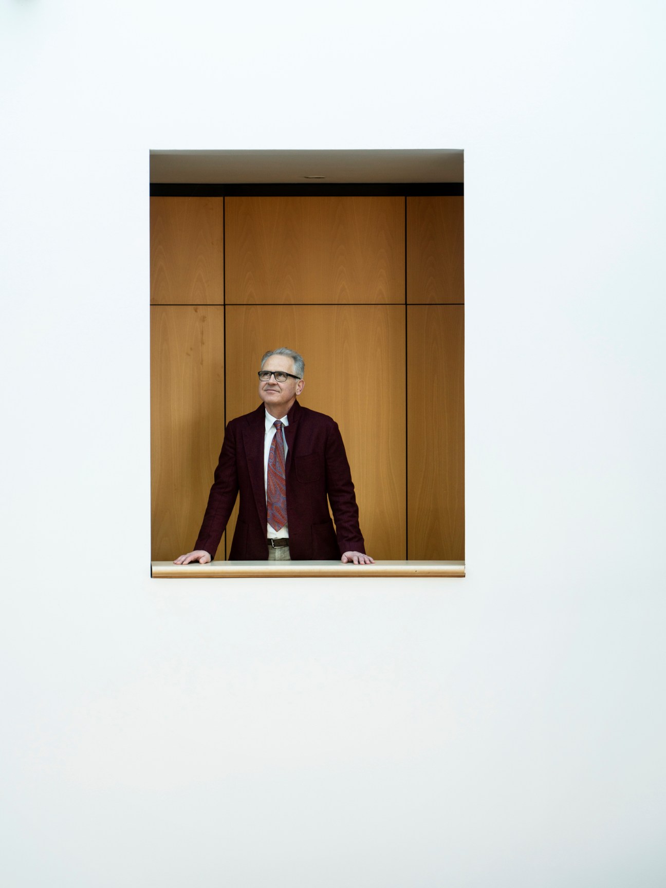 Dr Christof Germann, managing director of Illwerke VKW, stands at a wooden counter against a paneled wall.