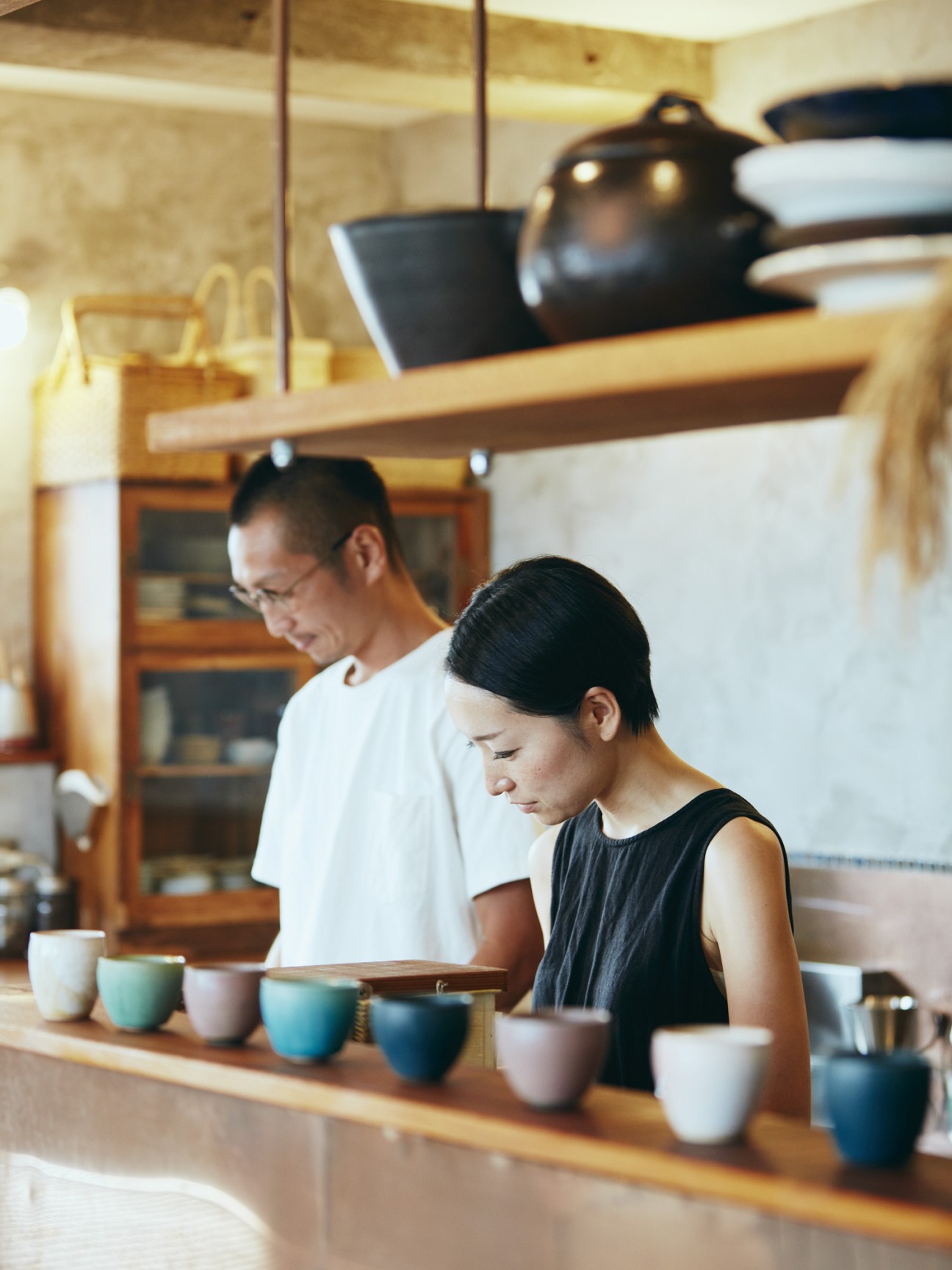 Go Komuro and his wife Yuko standing together in Hotel Aiaoi's kitchen