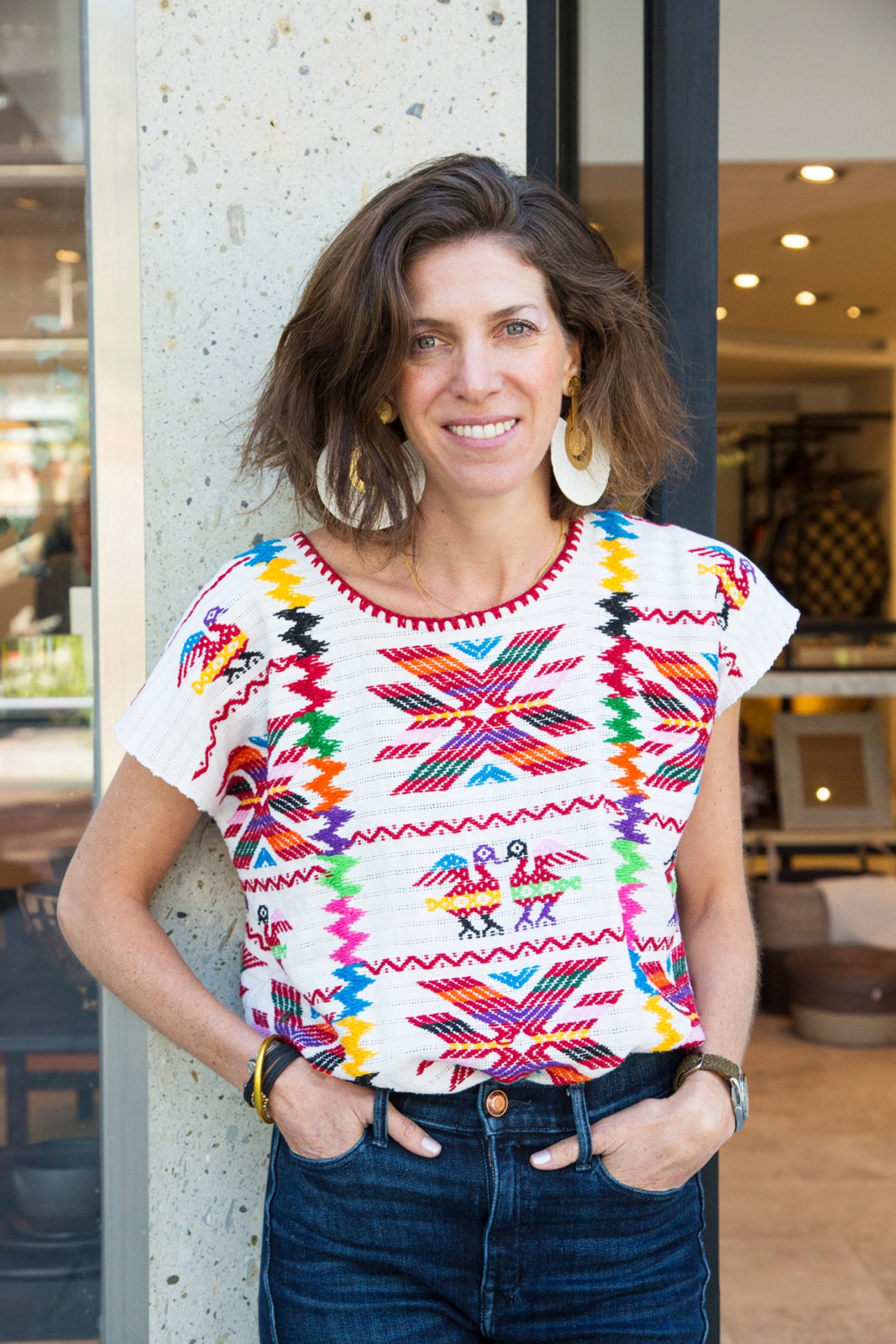 Lago owner Regina Barrios wearing a colorful traditional Mexican patterned top