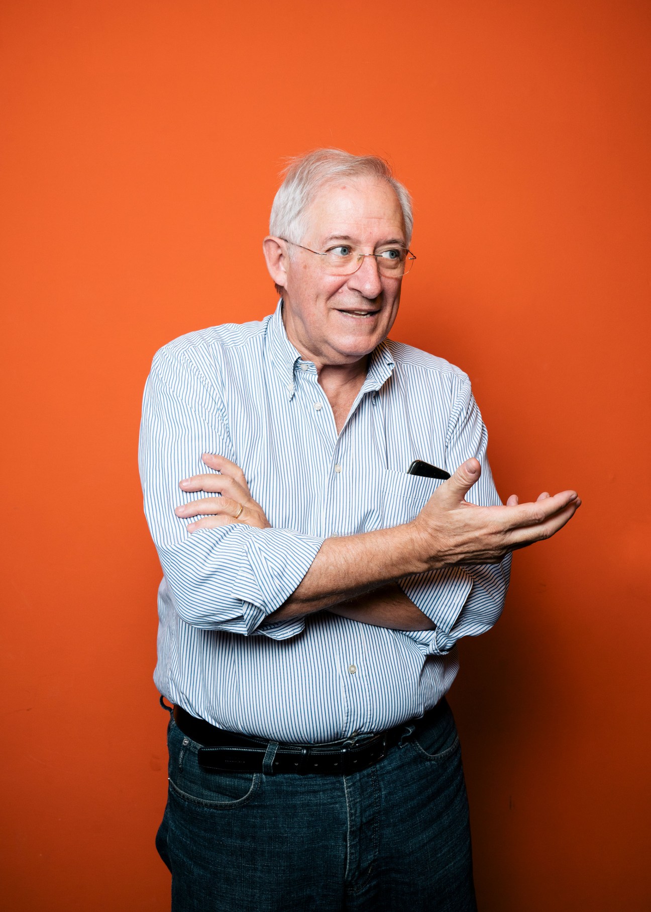Francisco Vilalta, head of production and circulation at Internazionale magazine, wearing a light blue striped shirt against an orange background.