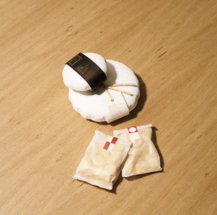 Zen Castella cakes in white paper packaging with red labels on wooden surface.