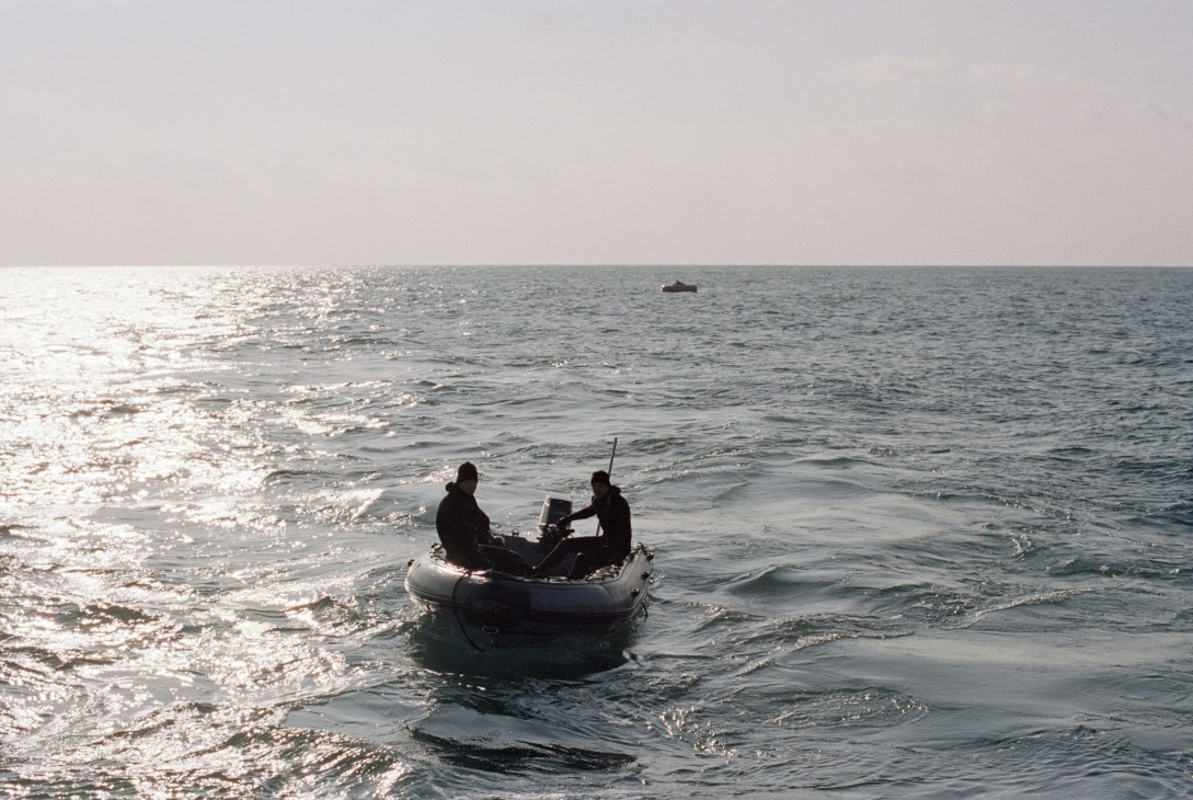 Two divers in a small inflatable boat on the Mediterranean Sea near Toulon.