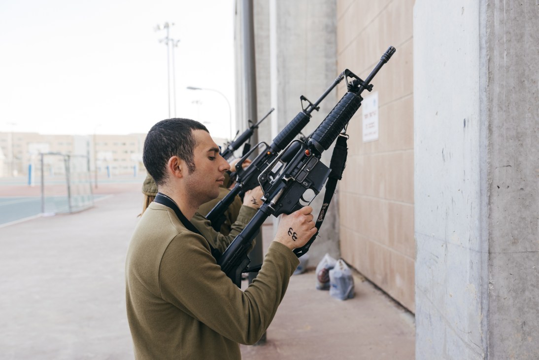 IDF soldier handling and aiming an assault rifle during weapons training at Ir Habahadim base.