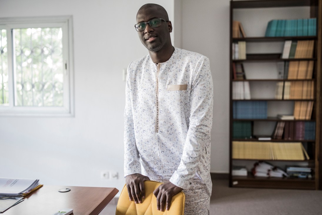 Economist Ndongo Sylla in his office with bookshelves behind him