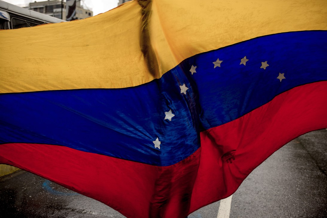 Venezuelan flag with yellow, blue and red stripes and white stars waving in the wind