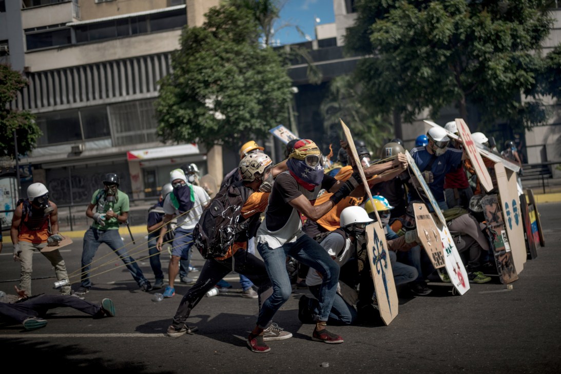 Protesters in Caracas with makeshift shields and face coverings during anti-government demonstrations