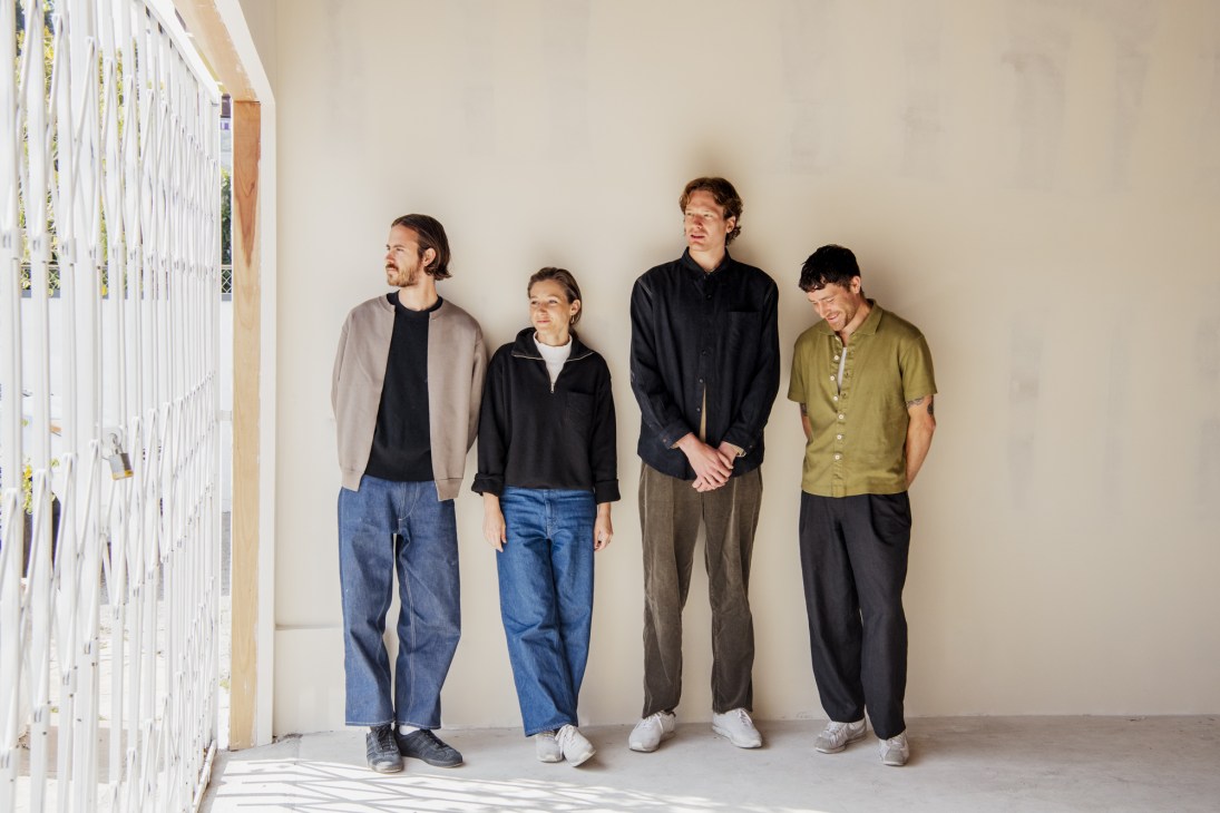 Four people standing against a white wall in casual clothing at Lady White Co headquarters.