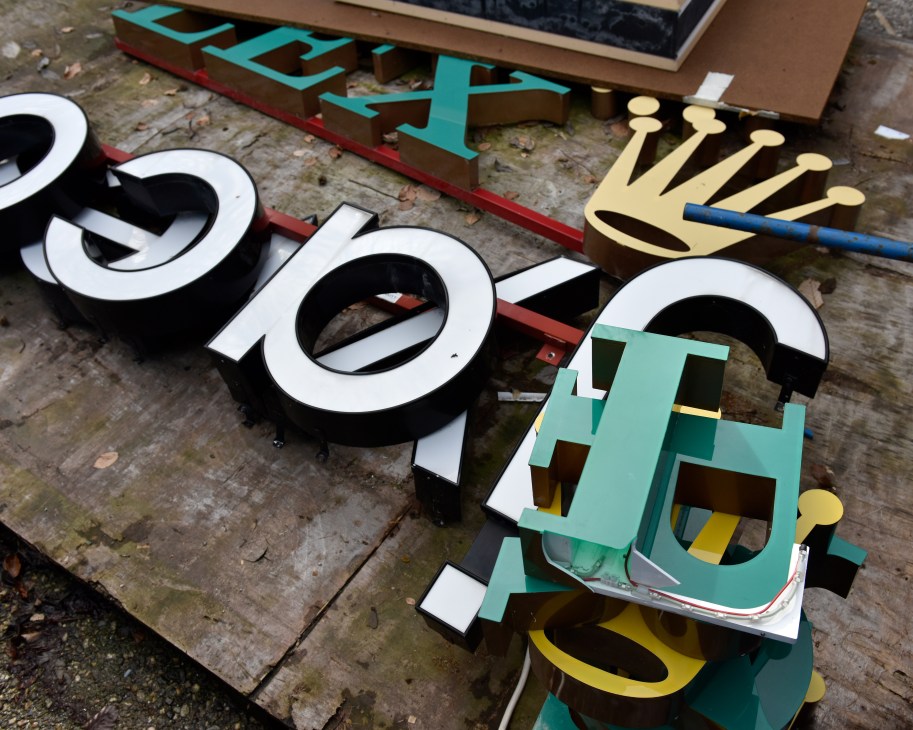 Large dimensional letters and signage pieces laid out on a cobblestone courtyard