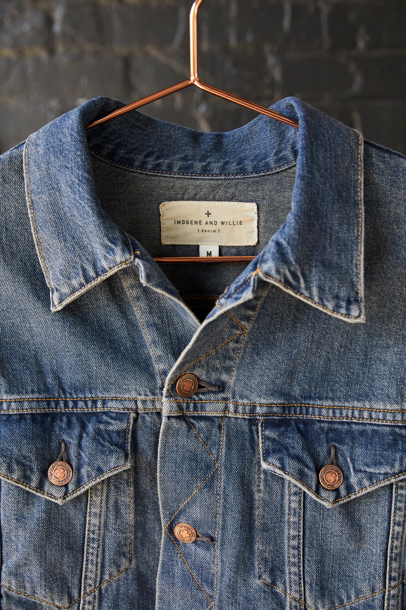 Imogene + Willie denim jacket on copper hanger displaying brand label and size M tag.