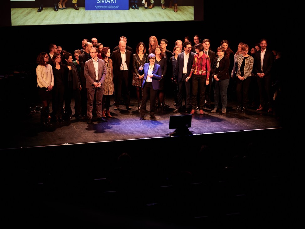 Group of performers and RATP team members standing on a theater stage during a Live Magazine performance.