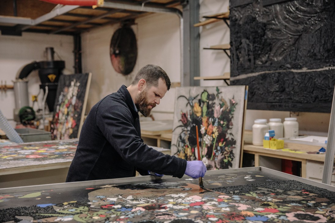Artist Matthew Day Jackson works on a colorful still-life composition in his studio.