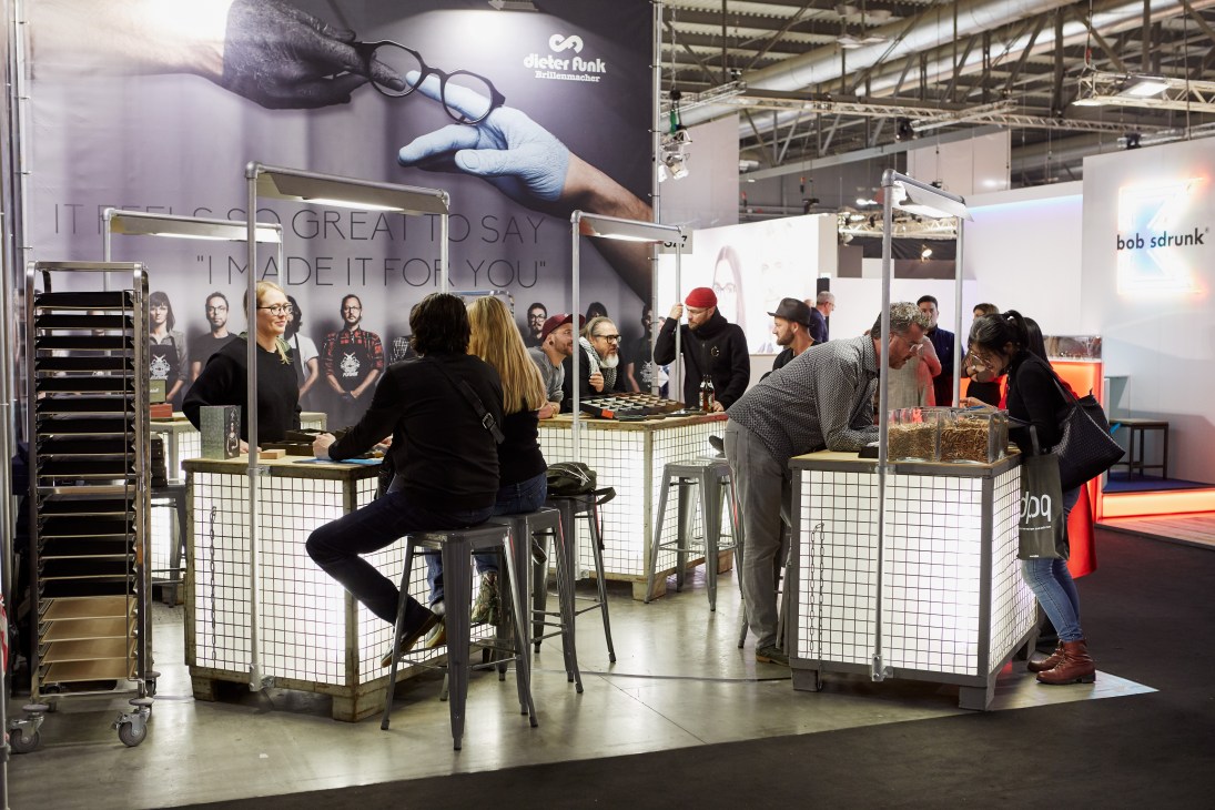 Visitors browse eyewear at the German brand Funk booth at the Mido trade show in Milan.