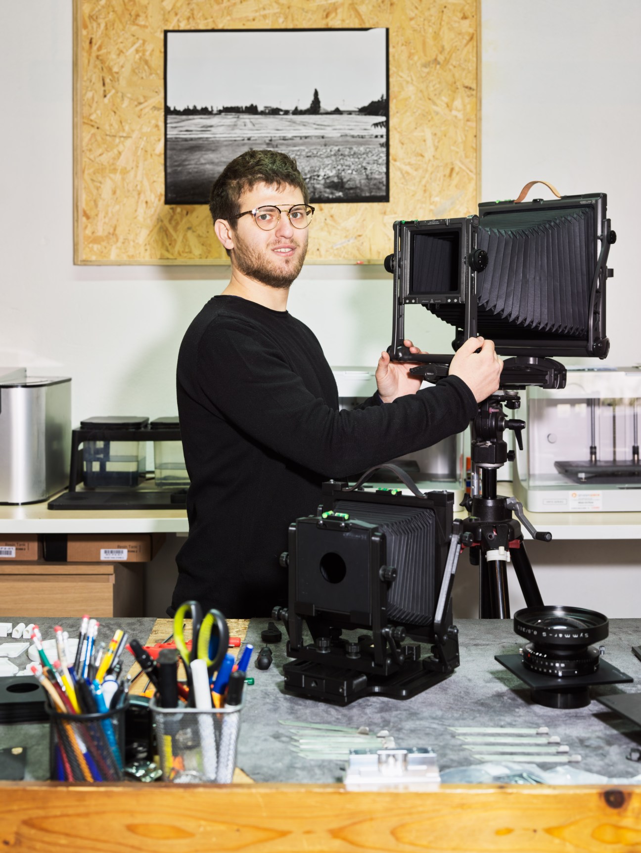Camera designer Alessandro Gibellini holds his GP810 large-format camera in his studio.