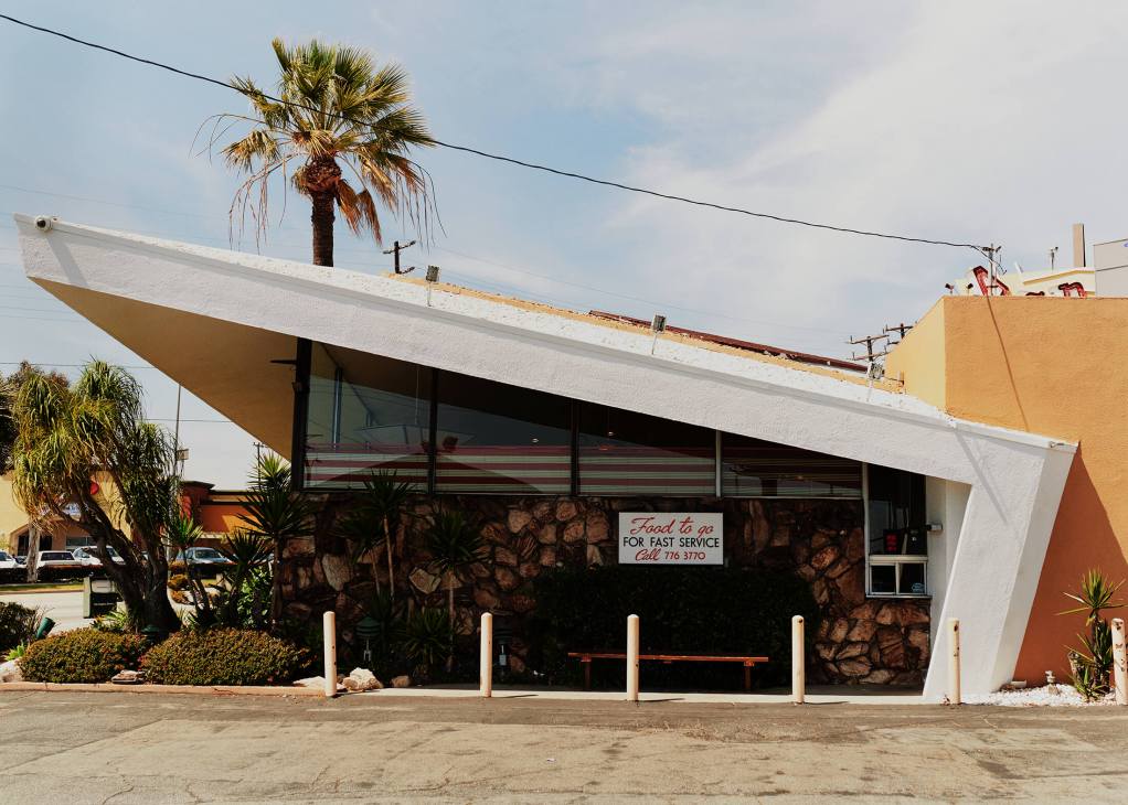 Pann's mid-century Googie diner with angular white roof, striped windows and stone facade exterior.