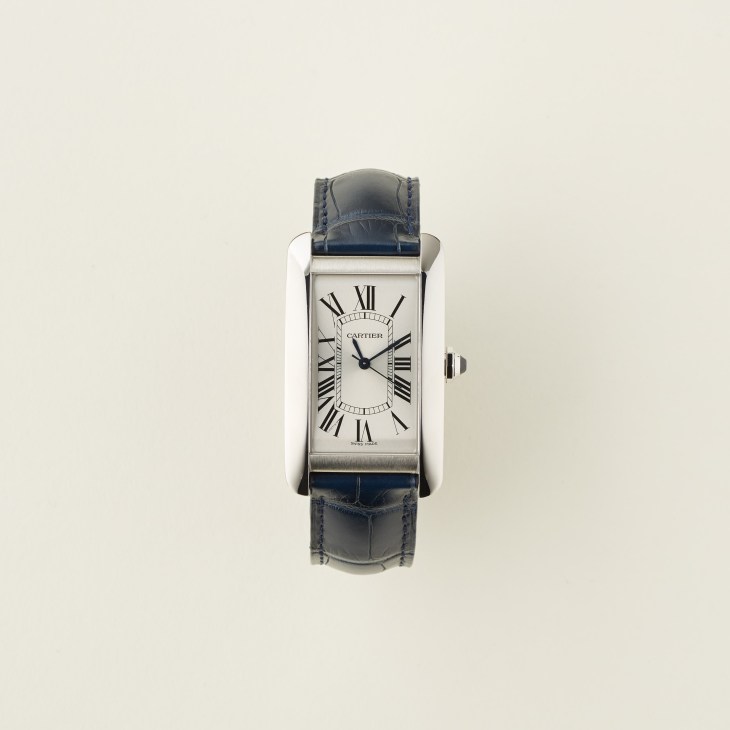 Tank américaine by Cartier luxury watch with rectangular silver case and blue leather strap.