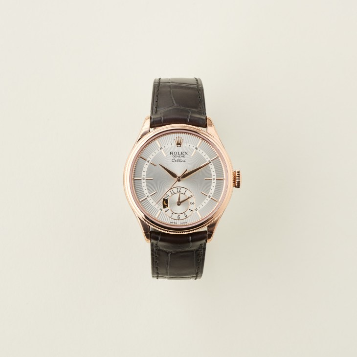 Rolex Cellini dual time watch with rose gold case and black leather strap