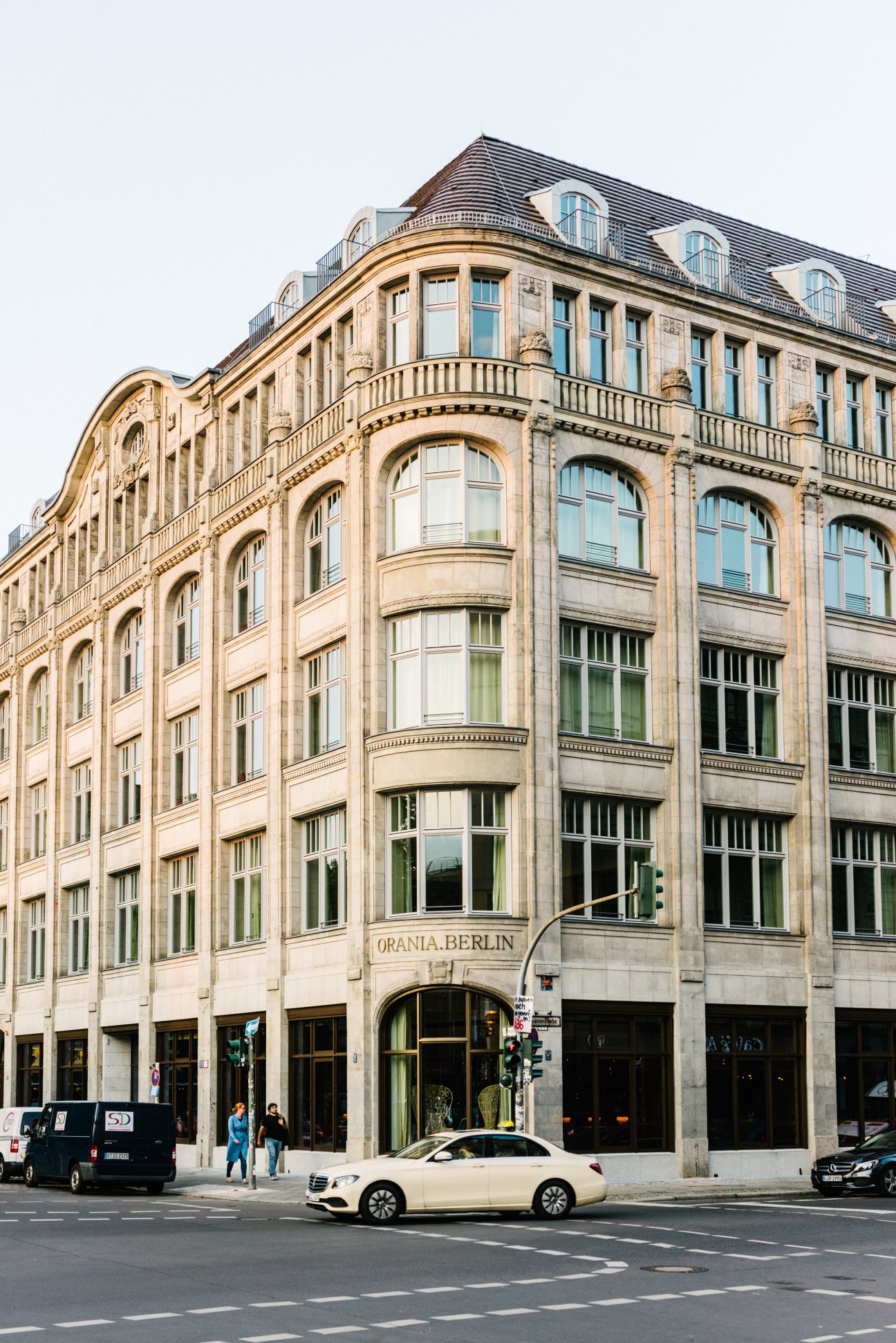 Orania Berlin's historic 1913 building on Oranienplatz with ornate stone facade and mansard roof.