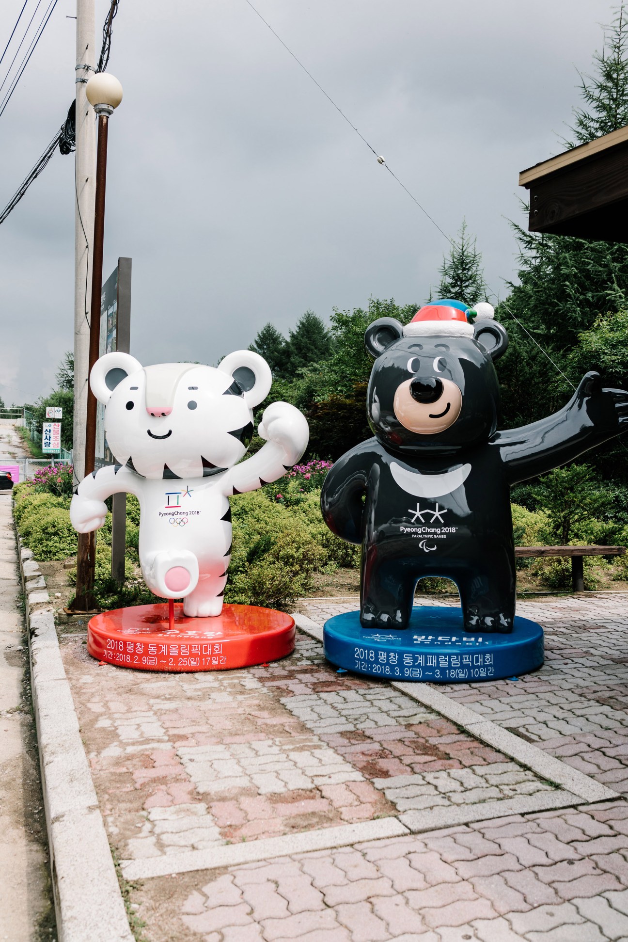 Winter Olympics mascots Soohorang and Bandabi statues displayed outdoors in Pyeongchang.