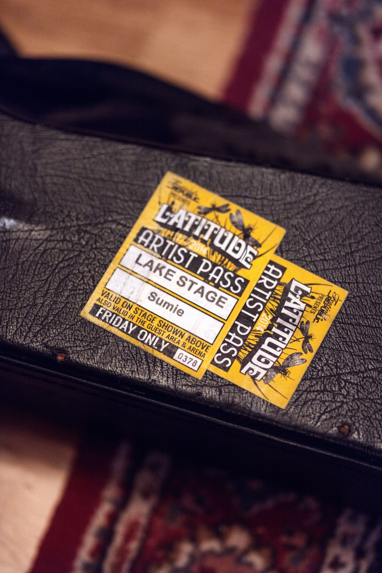 Latitude festival artist pass for Sumie at Lake Stage, yellow credential on black fabric.