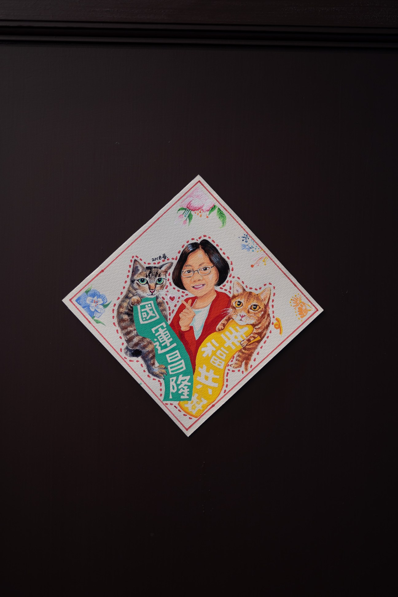 Decorative Chinese New Year art print showing Tsai Ing-wen with two cats and Chinese text on dark background.