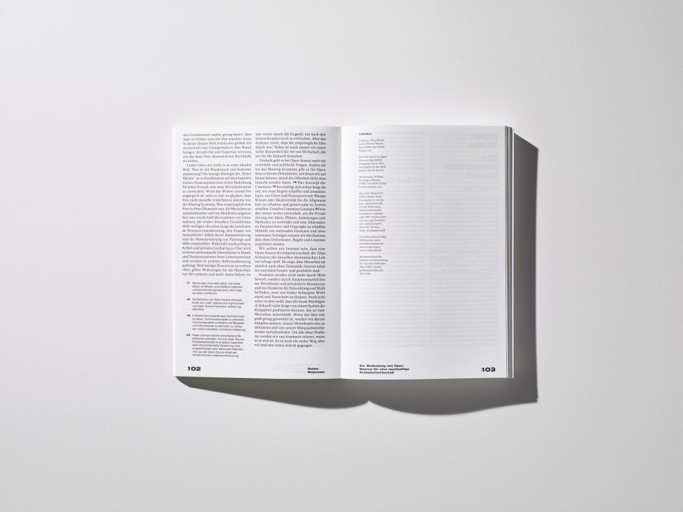 Open book spread showing German text and typography layouts on pages 102-103.
