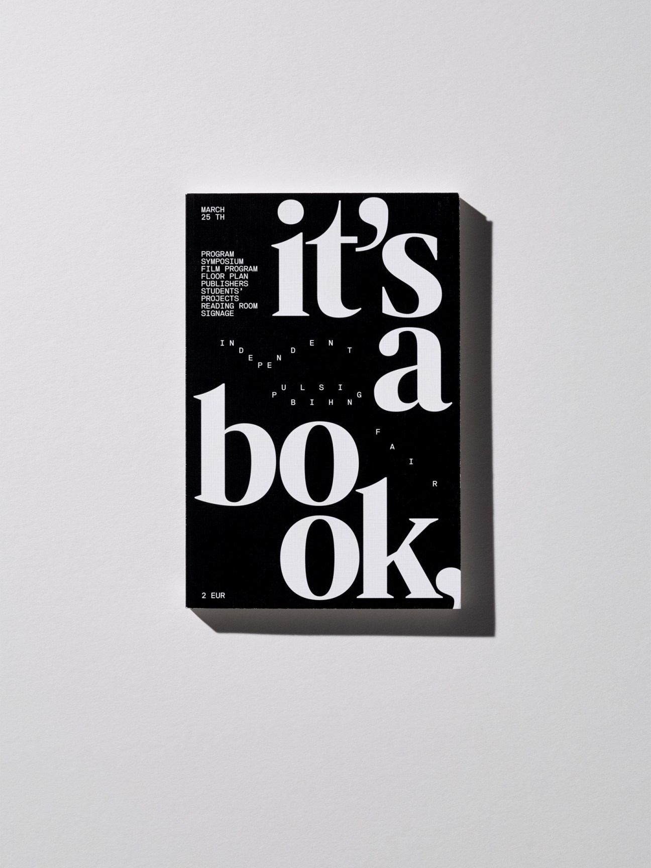 Black book cover with large white serif typography reading "it's a book" and smaller scattered text.