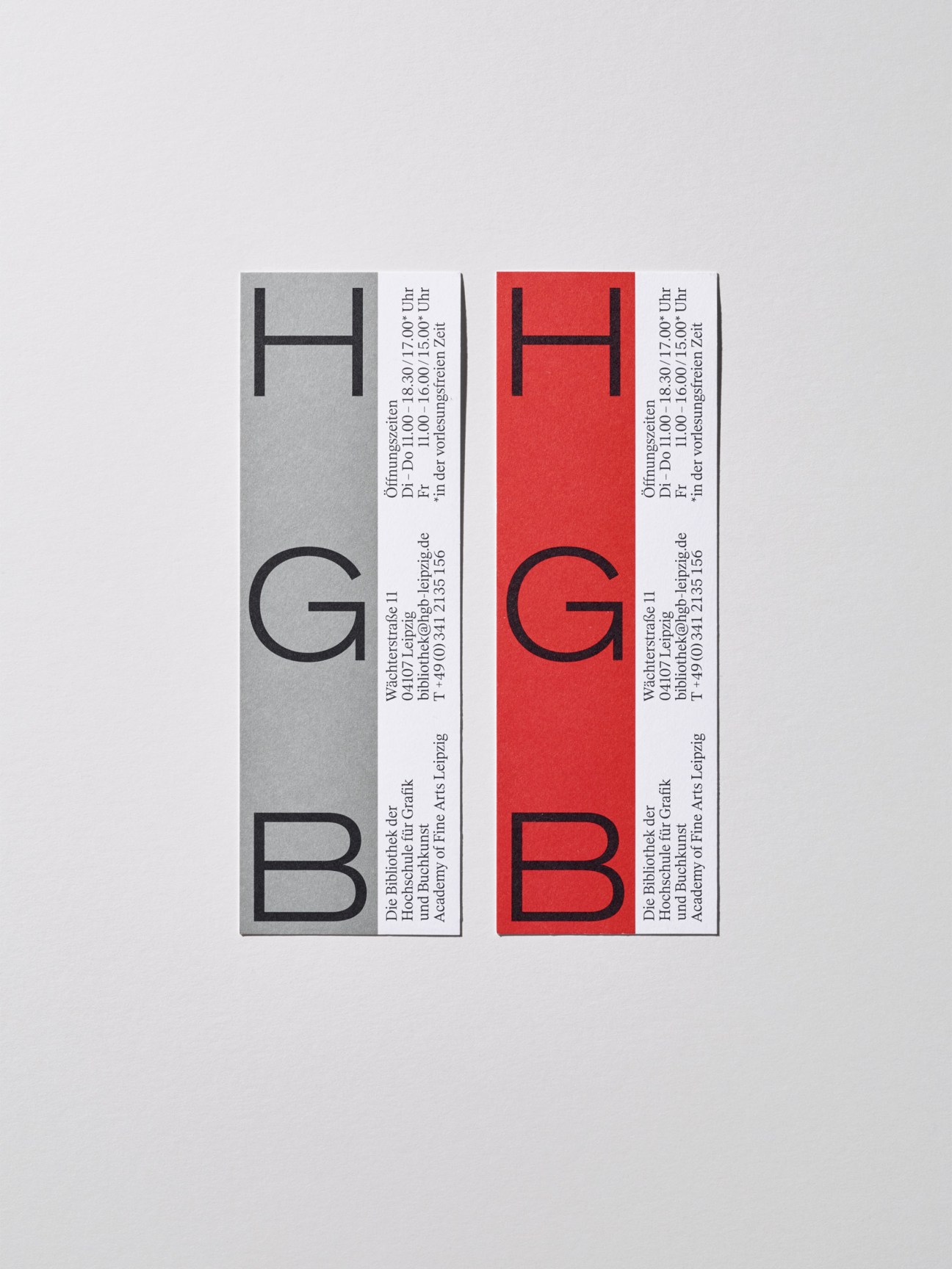 Two tall rectangular bookmarks with black H and G letters on grey and red backgrounds, printed promotional materials for HGB.