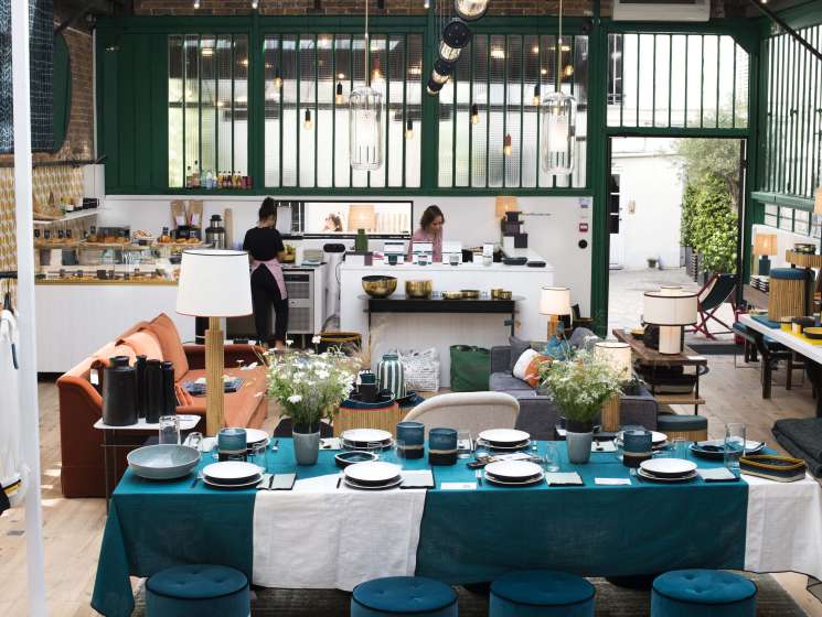 Sarah Lavoine's showroom displaying tableware, furniture and home décor in signature blue and terracotta tones.