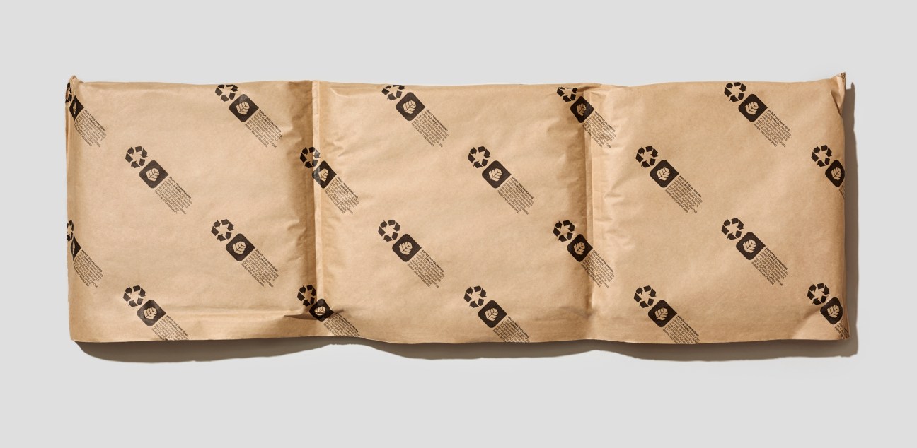 TemperPack's fully recyclable paper-based insulator sheets with recycling symbols printed diagonally across tan cardboard.