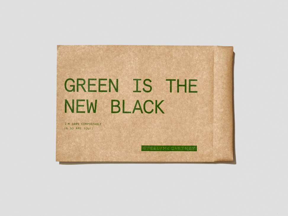 Kraft paper envelope with green text reading 'Green is the new black' and Stella McCartney branding