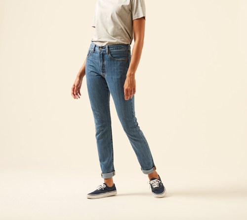 Person wearing Levi's 501 skinny jeans in classic blue wash with slim-tapered fit.