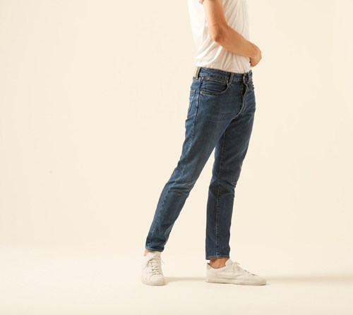 Woman wearing DP jeans by Golden Goose in dark blue with tailored fit and white sneakers