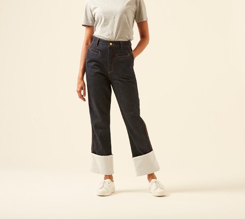 Woman wearing Fisherman jeans by Loewe with wide relaxed fit and light cuffed hem.