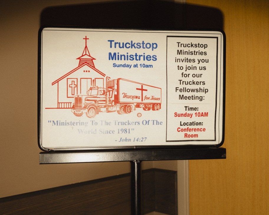 Sign advertising Truckstop Ministries Sunday services at 10am with illustration of chapel and truck.
