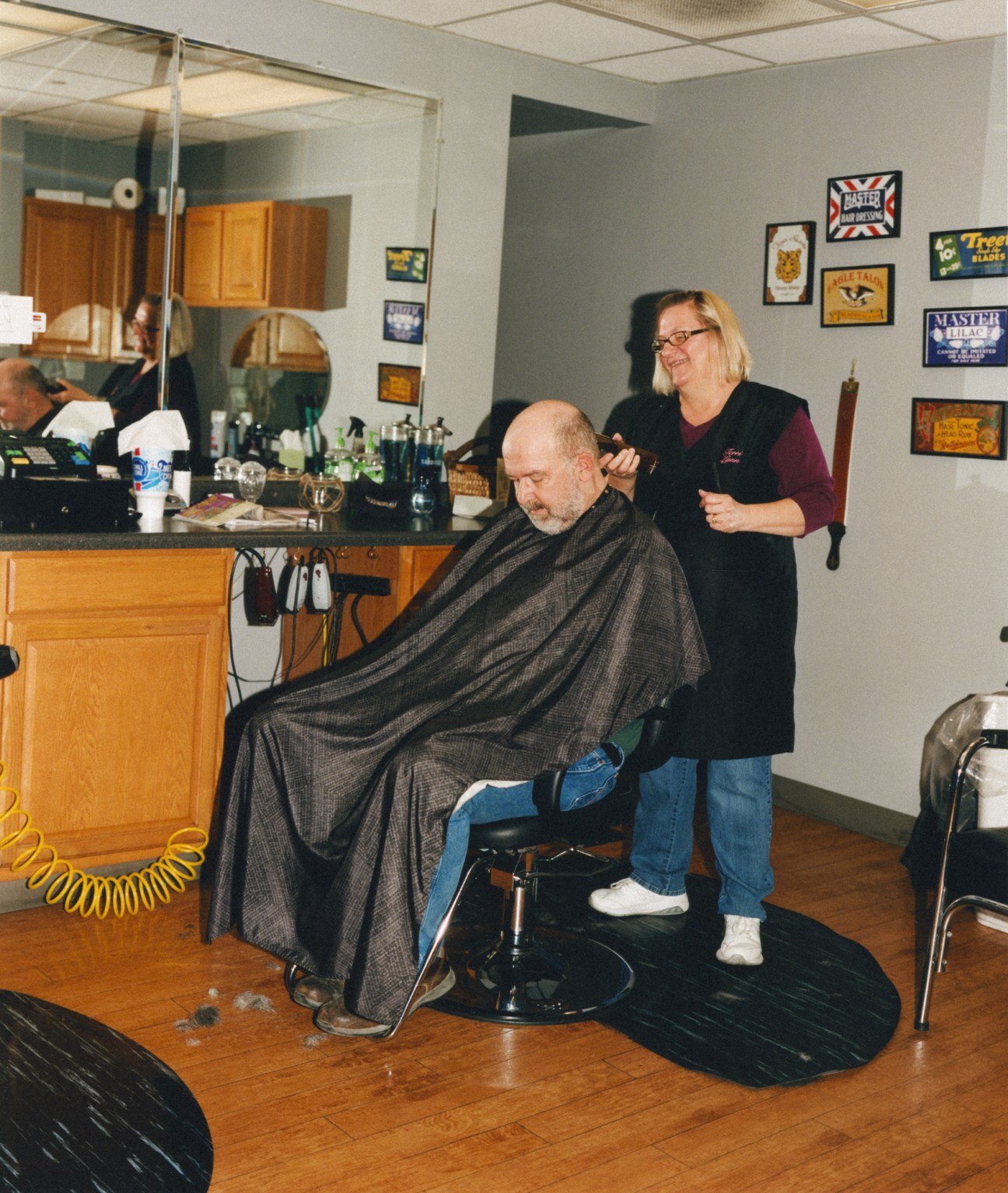 Barber Terri Gaines cutting a trucker's hair at Iowa 80's barbershop.