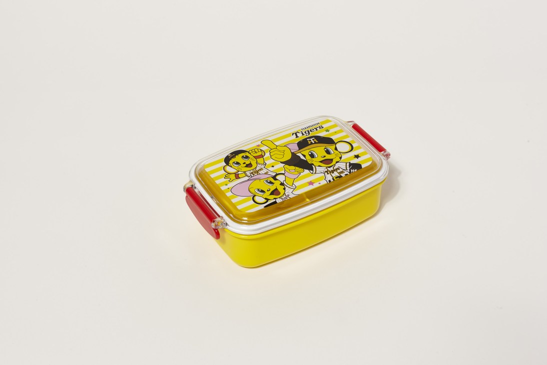 Yellow bento box with Hanshin Tigers mascot characters and striped design, featuring red handles and clear lid.