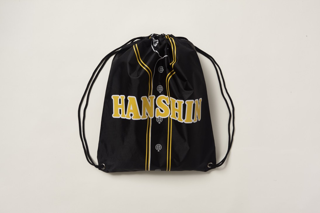 Black drawstring bag with yellow trim displaying Hanshin Tigers baseball team branding and logo.
