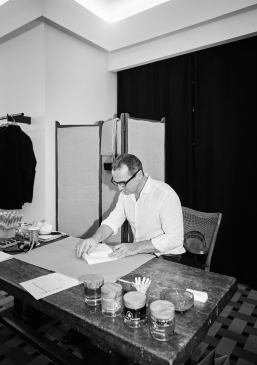 Christophe Campagnola, founder of Maison Rucher, working at a desk in his studio.