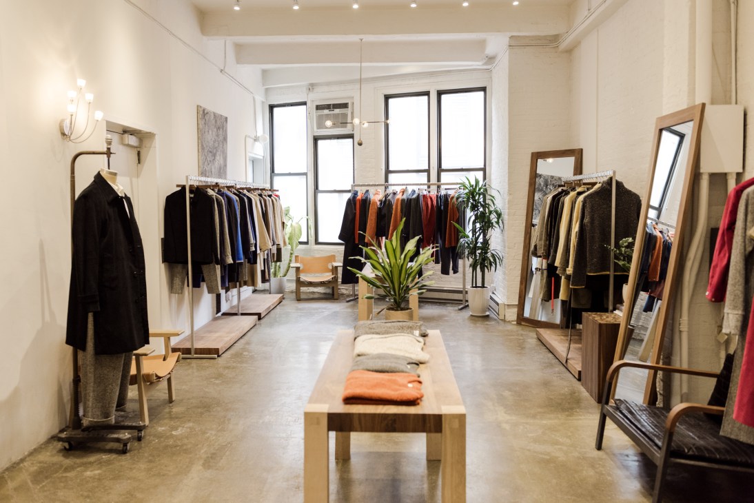 Deveaux's Tribeca studio and showroom with clothing racks, mirrors, and wood furnishings.