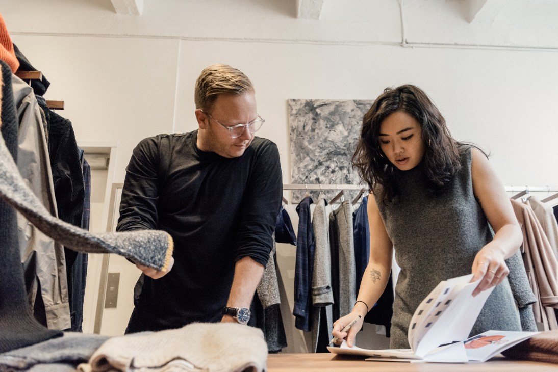 Matthew Breen and Andrea Tsao reviewing fabric samples and buyer selections at Deveaux studio.