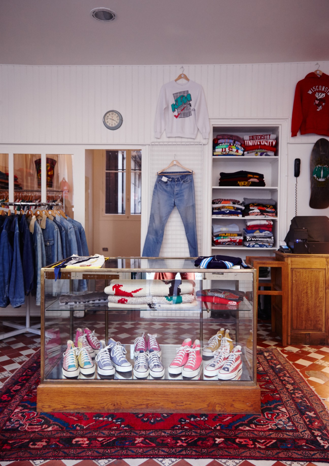 Display case of colorful canvas sneakers and trainers in La Vif vintage shop